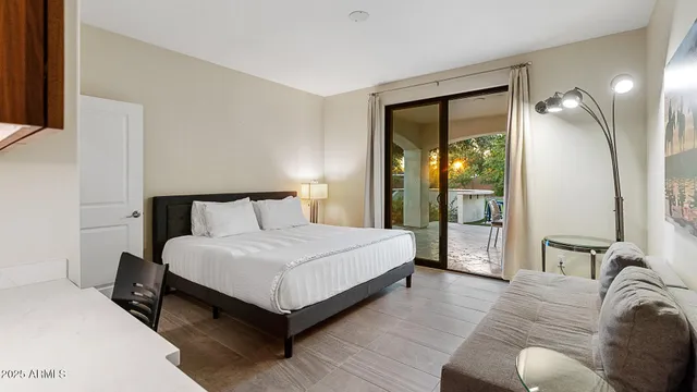 a bedroom with bed and a mirror