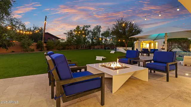 a backyard of a house with outdoor seating