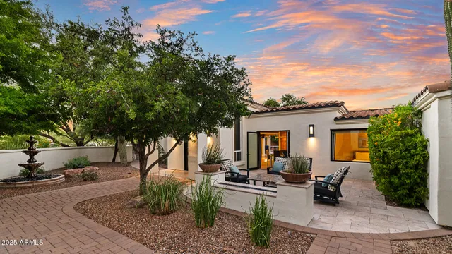 a view of a house with backyard and sitting area