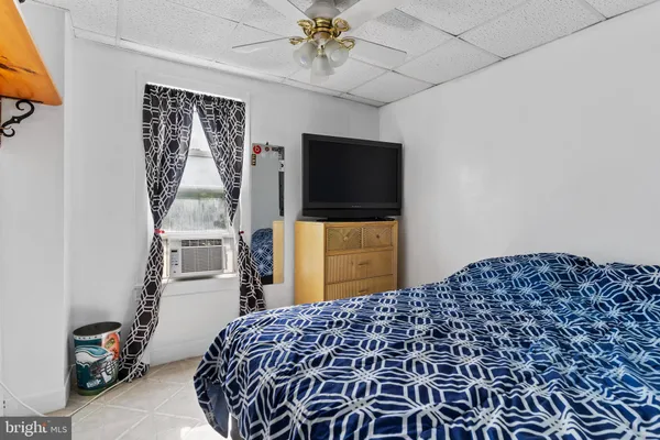 a bedroom with a bed and a television