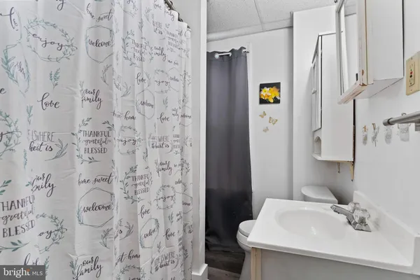 a bathroom with a sink and mirror with toilet