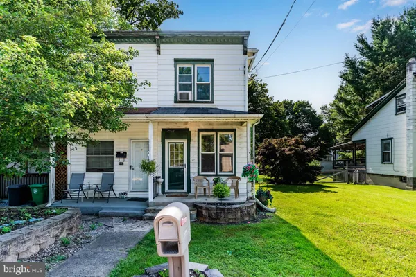 a front view of house with a garden and patio