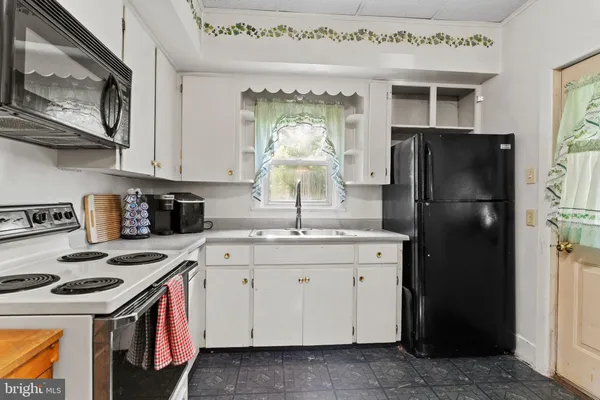 a kitchen with stainless steel appliances granite countertop a stove a refrigerator and a refrigerator