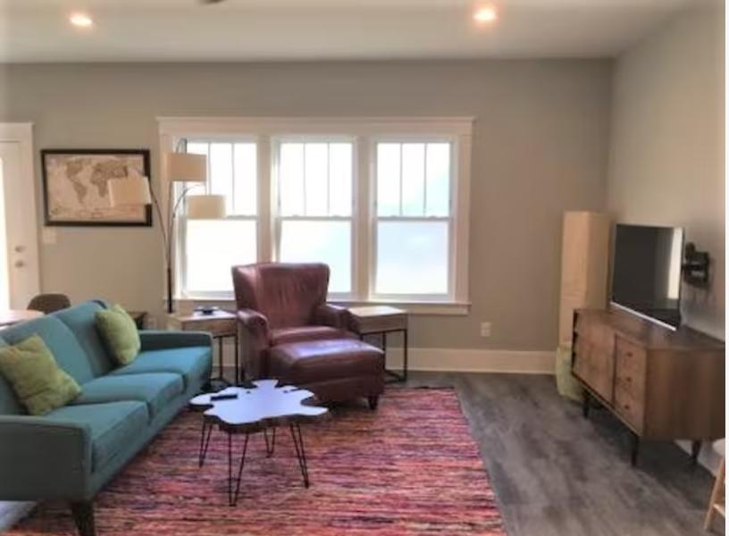 1433 Acadia Street, Unit DOWN Durham, NC 27701 - Photo 3 of 7 a living room with furniture and a flat screen tv