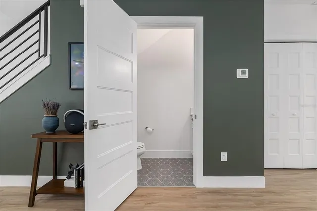 a bedroom with a large bed a flat tv screen and dresser