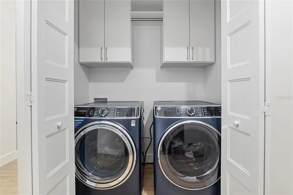 a utility room with sink dryer and washer