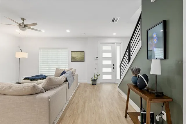 a living room with furniture and a wooden floor