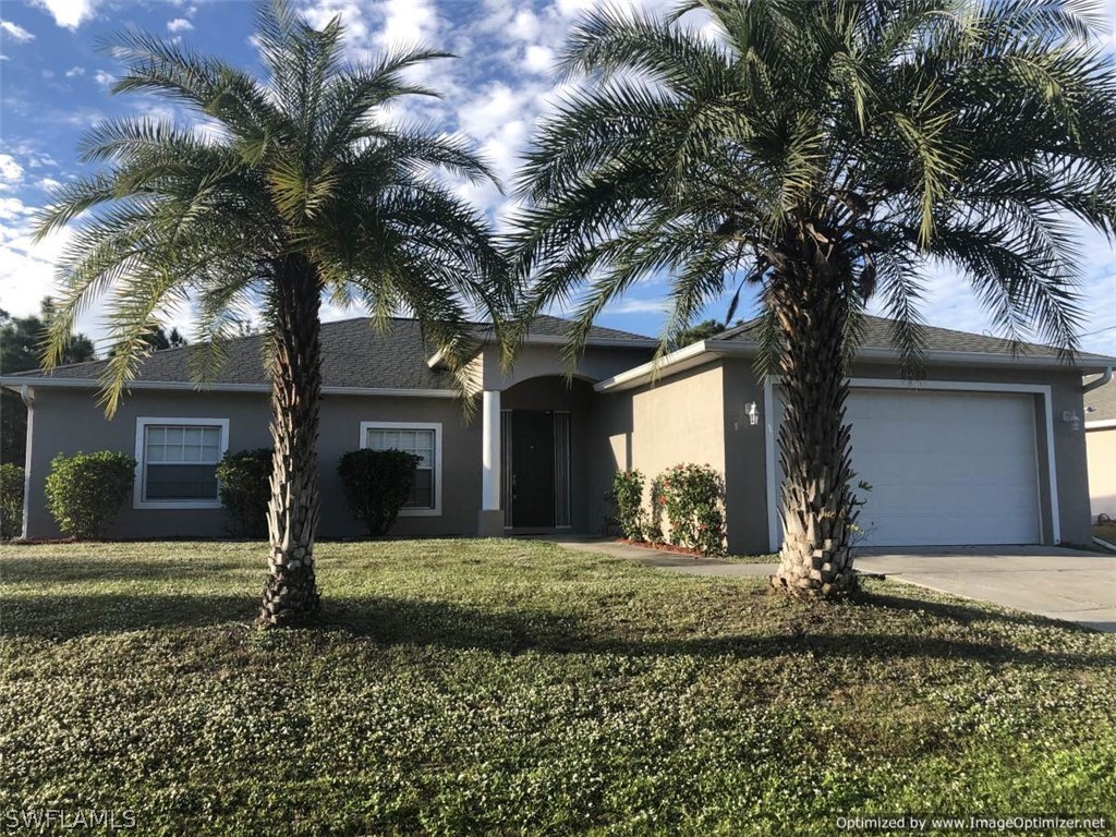 2983 Point Street North Port, FL 34286 - Photo 1 of 19 a front view of a house with a yard