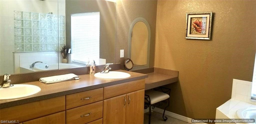 2983 Point Street North Port, FL 34286 - Photo 11 of 19 a bathroom with a granite countertop sink and a mirror