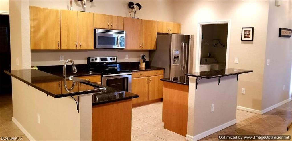 2983 Point Street North Port, FL 34286 - Photo 3 of 19 a kitchen with stainless steel appliances granite countertop a refrigerator and a stove