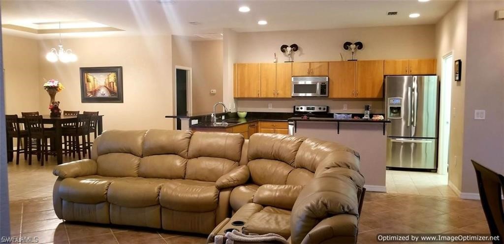 2983 Point Street North Port, FL 34286 - Photo 5 of 19 a living room with furniture kitchen view and a refrigerator