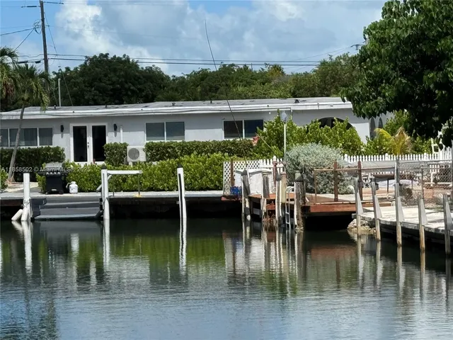 a front view of house with yard and outdoor seating