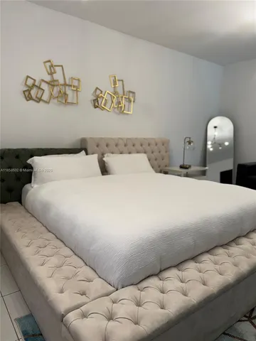 a bedroom with a bed and a view of kitchen