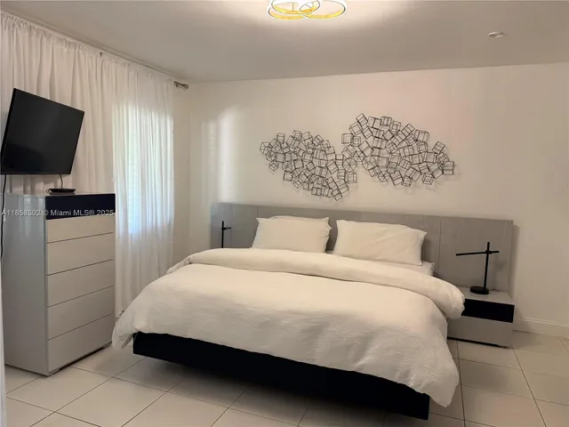 a view of a patio with couches and table and chairs with wooden floor