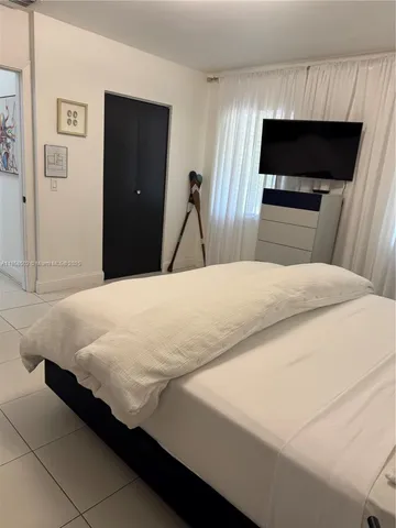 a view of a swimming pool with a patio and a garden