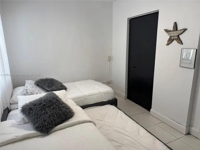 a living room with furniture a large window and a flat screen tv