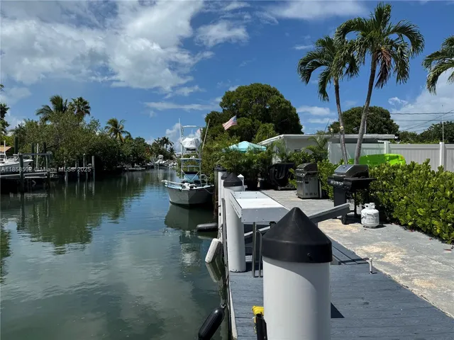 a kitchen with refrigerator and cabinets