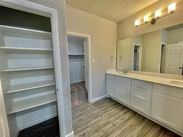 a spacious bathroom with a double vanity sink and a mirror