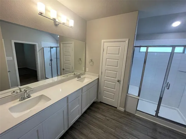 a bathroom with a double vanity sink and a mirror