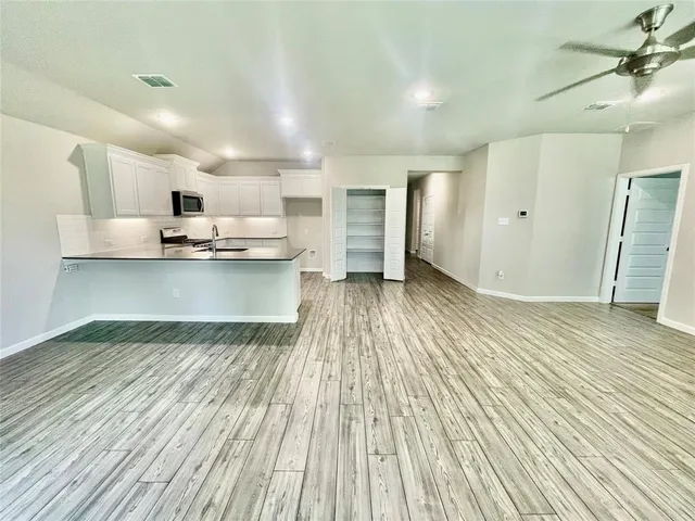 a view of kitchen with furniture and wooden floor