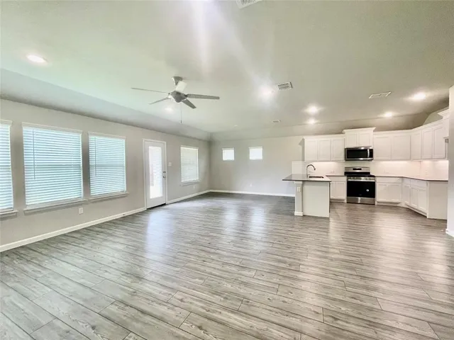 a view of kitchen with furniture and wooden floor