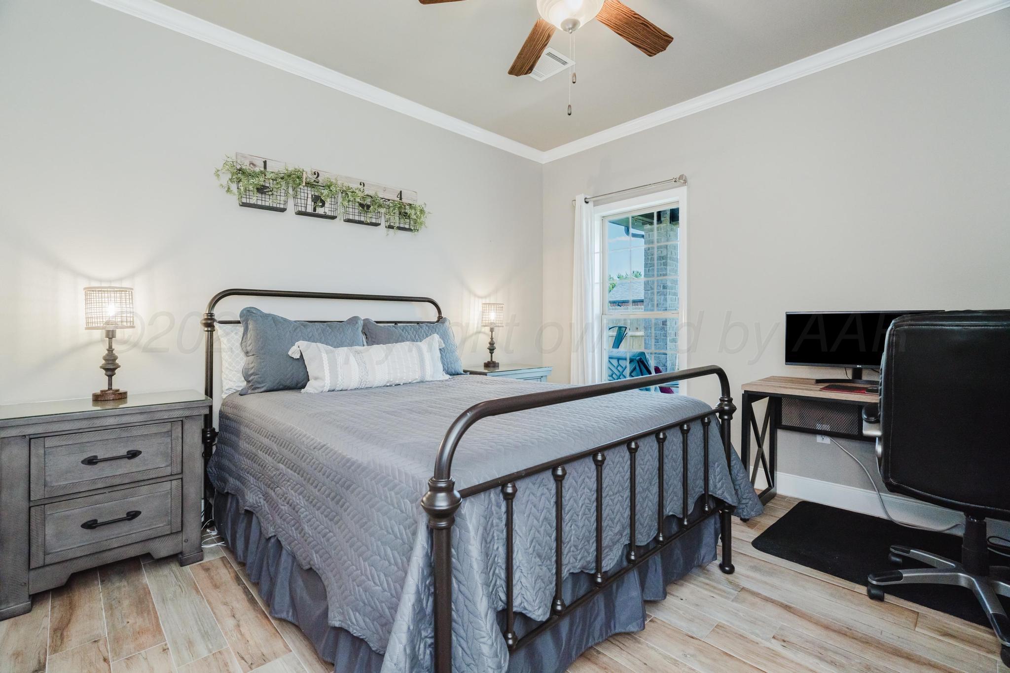 9011 Staten Island Amarillo, TX 79119 - Photo 11 of 17 a bedroom with a bed and a desk