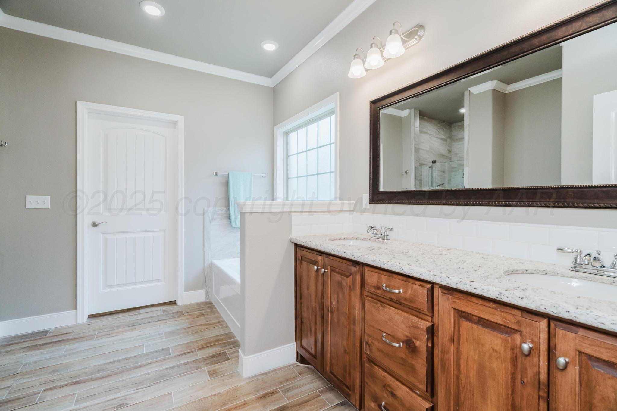 9011 Staten Island Amarillo, TX 79119 - Photo 13 of 17 a bathroom with a sink and a mirror