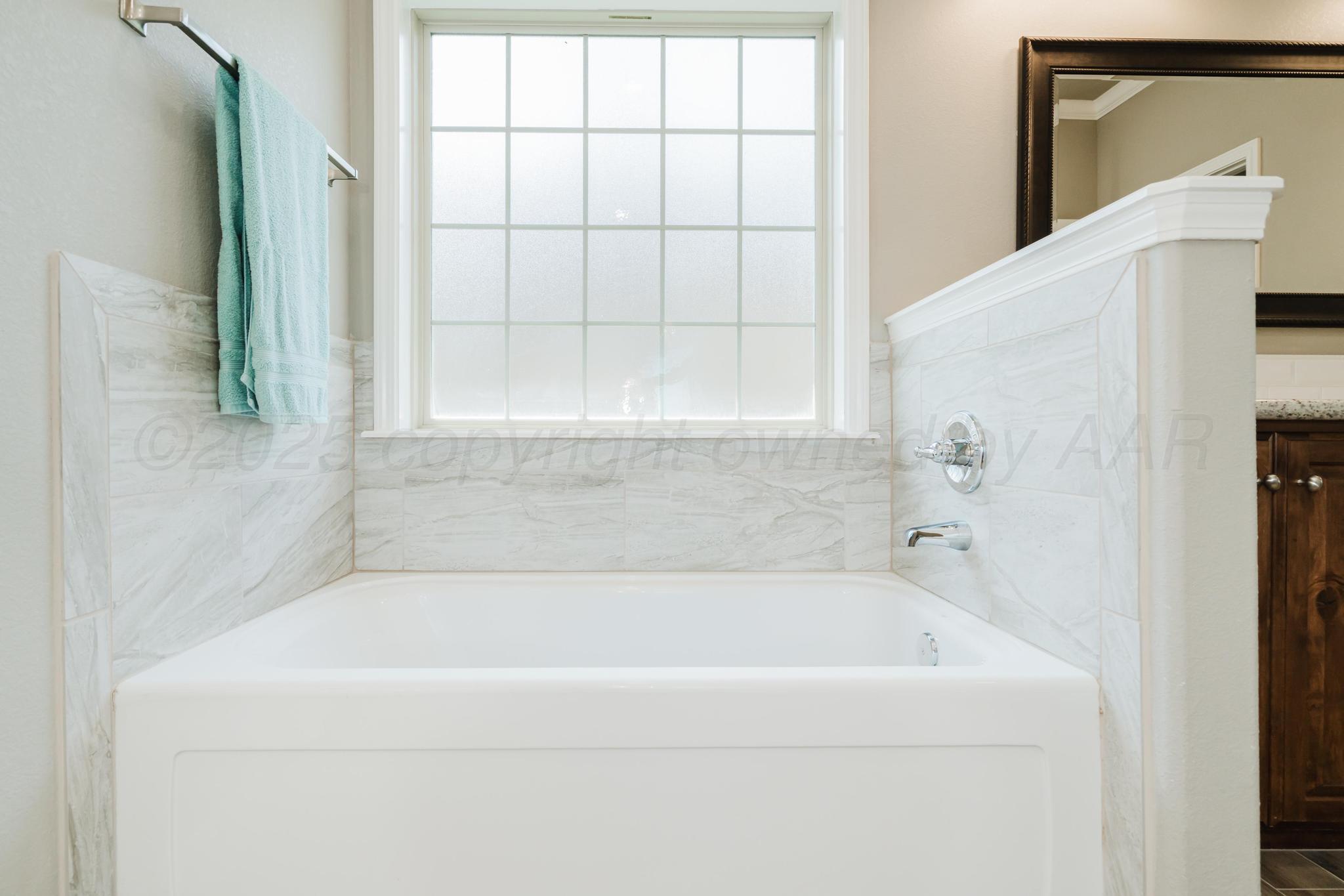 9011 Staten Island Amarillo, TX 79119 - Photo 15 of 17 a white bath tub sitting next to a window