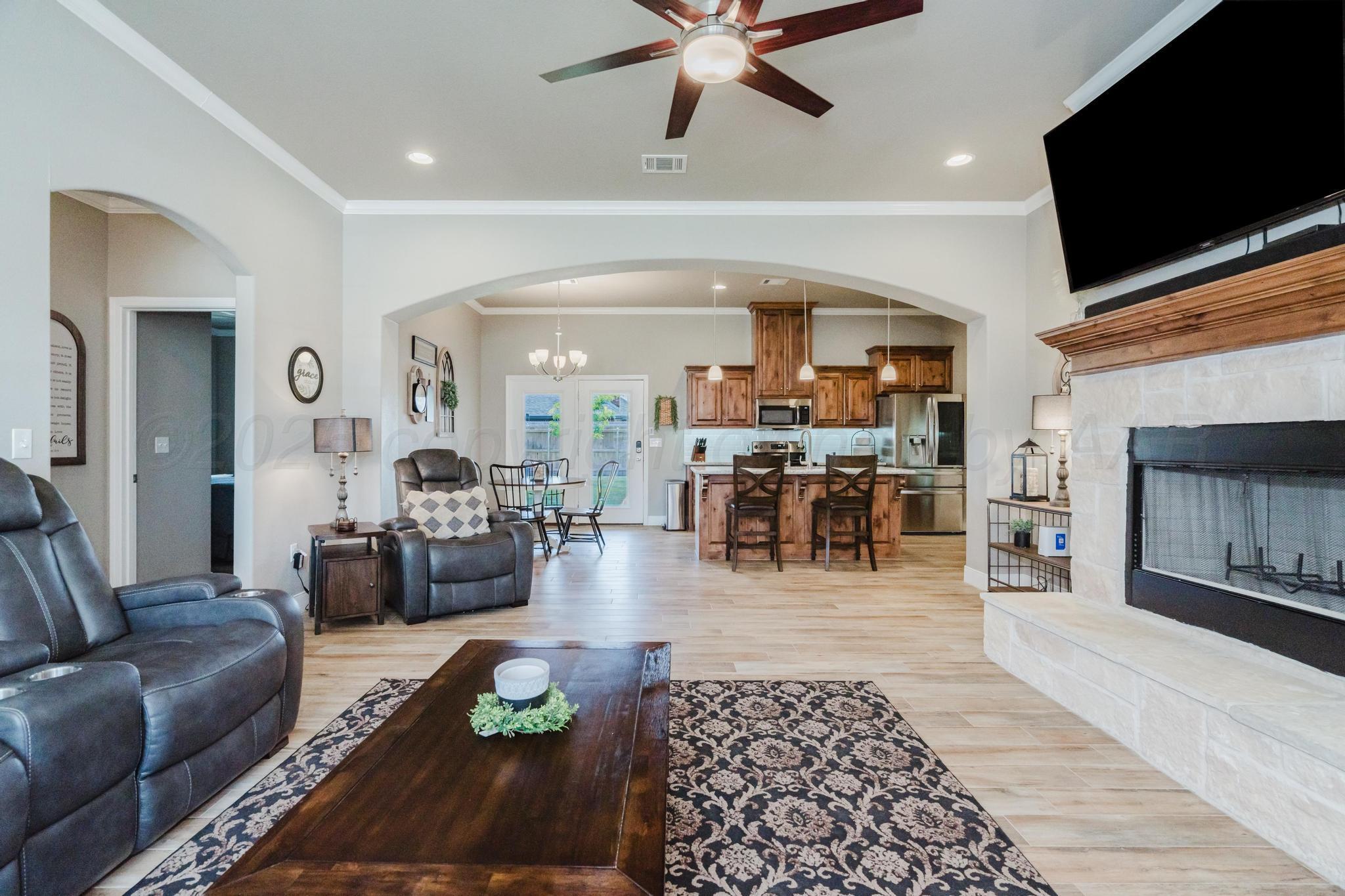 9011 Staten Island Amarillo, TX 79119 - Photo 4 of 17 a living room with furniture and a flat screen tv