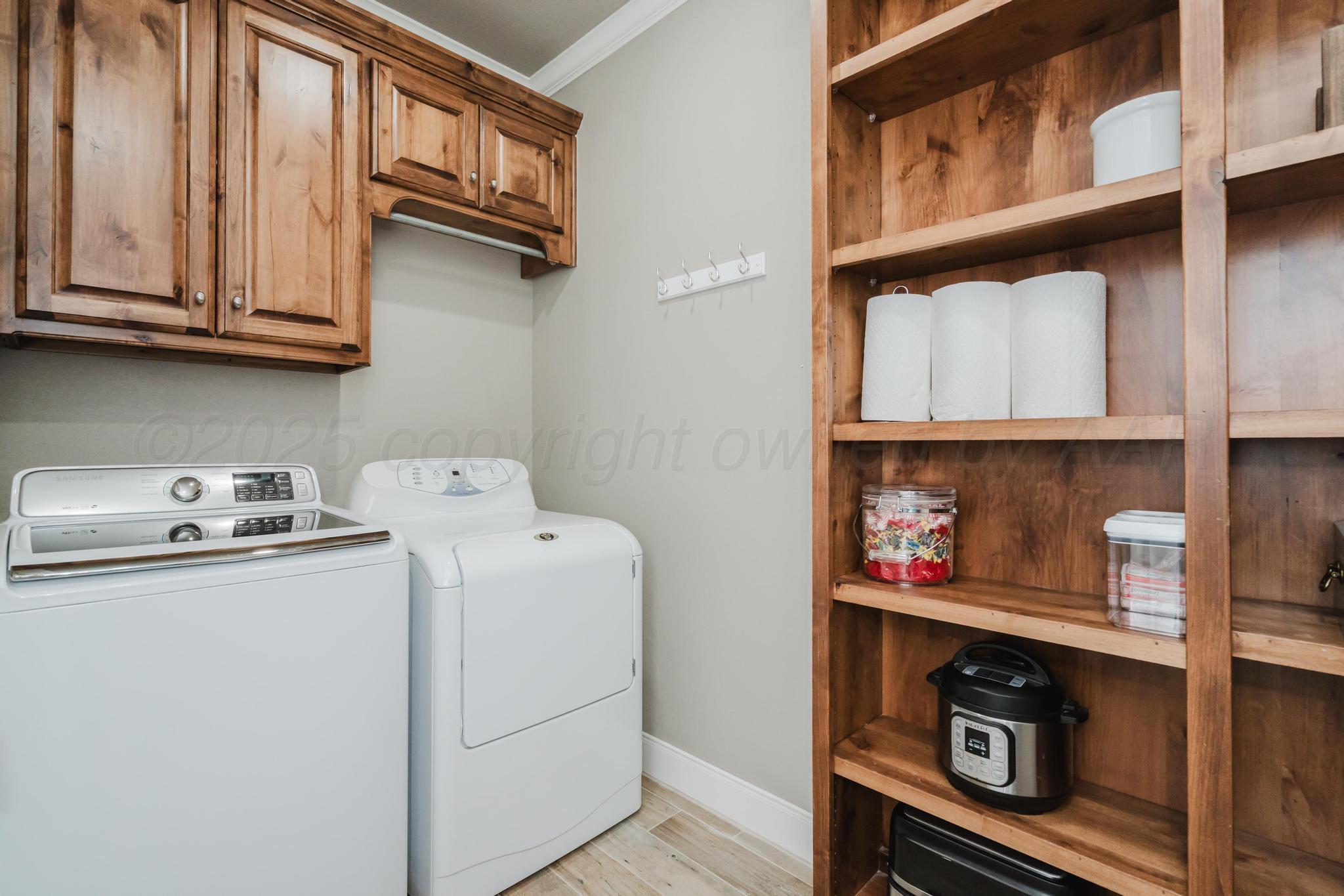 9011 Staten Island Amarillo, TX 79119 - Photo 8 of 17 a view of storage and utility room with washer and dryer