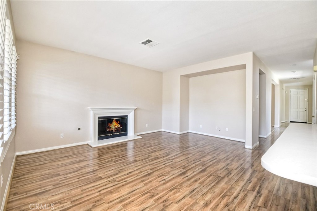 28961 Savannah Drive Temecula, CA 92591 - Photo 13 of 54 a view of an empty room with wooden floor fireplace and a window