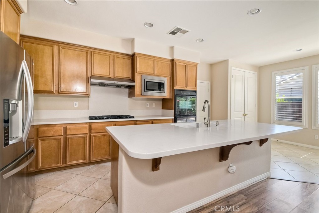 28961 Savannah Drive Temecula, CA 92591 - Photo 17 of 54 a kitchen with stainless steel appliances granite countertop a sink a stove and cabinets