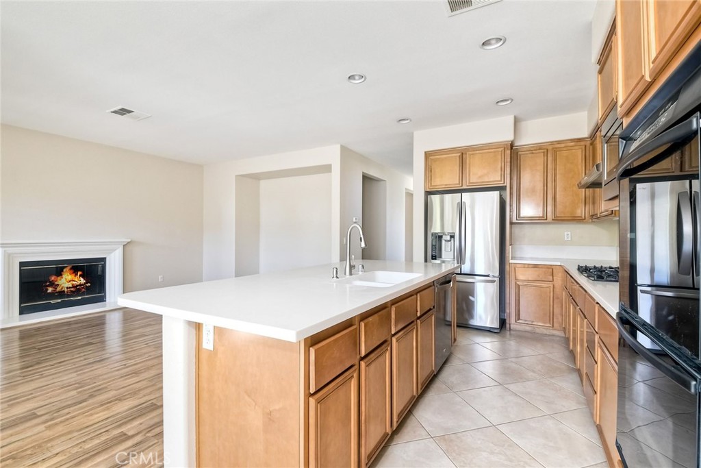 28961 Savannah Drive Temecula, CA 92591 - Photo 18 of 54 a kitchen with stainless steel appliances a sink stove and a refrigerator