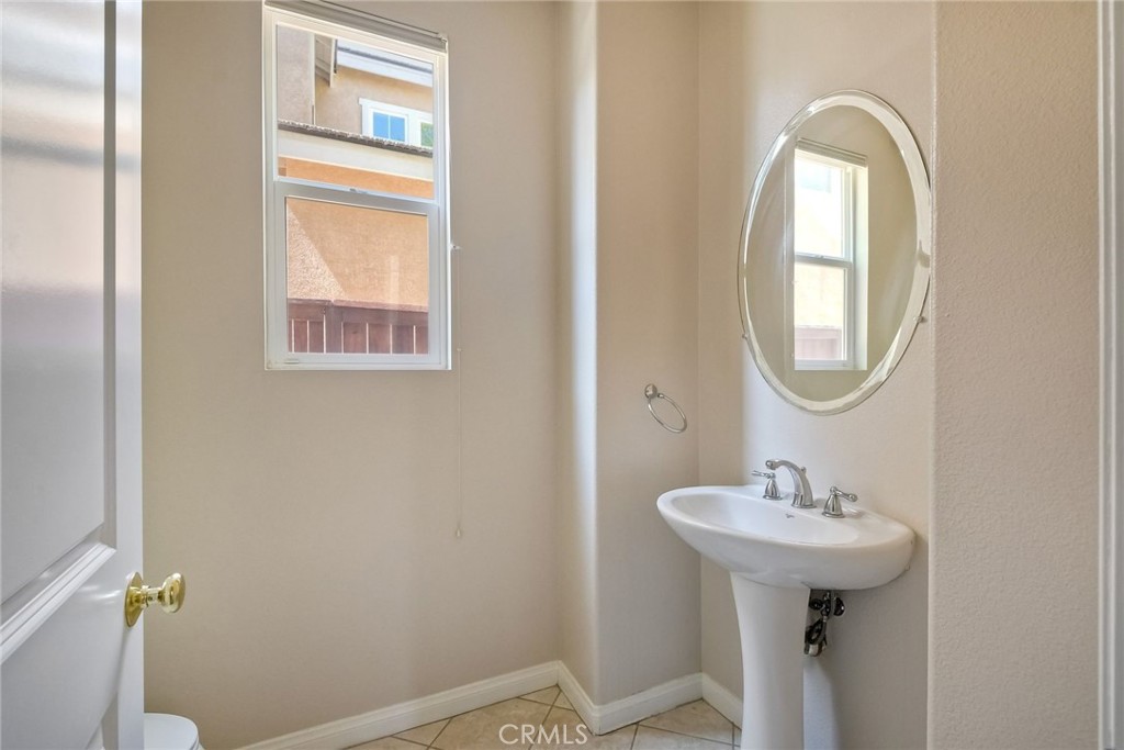 28961 Savannah Drive Temecula, CA 92591 - Photo 23 of 54 a bathroom with a sink mirror and toilet