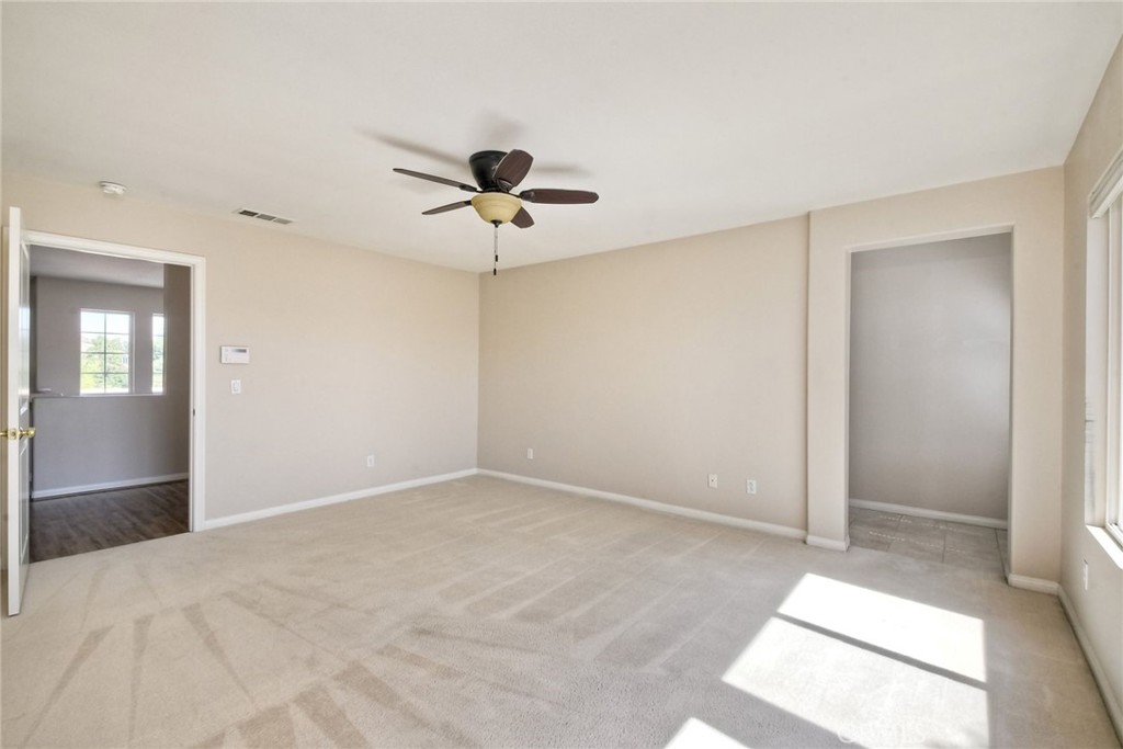 28961 Savannah Drive Temecula, CA 92591 - Photo 29 of 54 an empty room with chandelier fan and windows