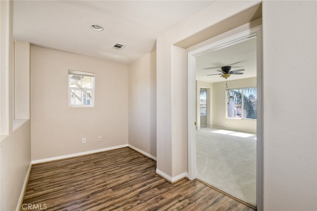 28961 Savannah Drive Temecula, CA 92591 - Photo 32 of 54 a view of an empty room with wooden floor and a window