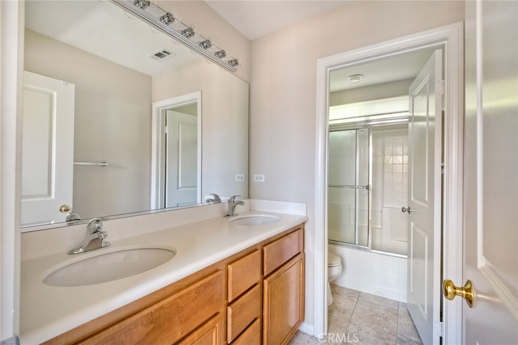28961 Savannah Drive Temecula, CA 92591 - Photo 34 of 54 a bathroom with a sink double vanity and a mirror
