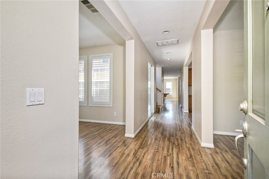 28961 Savannah Drive Temecula, CA 92591 - Photo 5 of 54 a view of a hallway with wooden floor