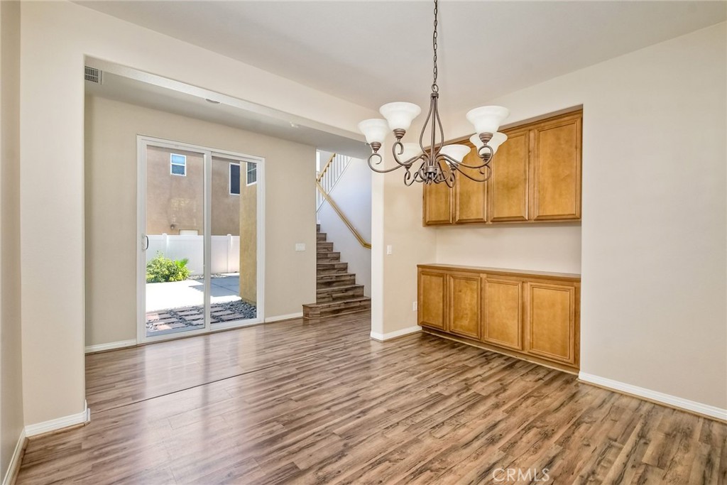 28961 Savannah Drive Temecula, CA 92591 - Photo 9 of 54 a view of a room with wooden floor staircase and windows