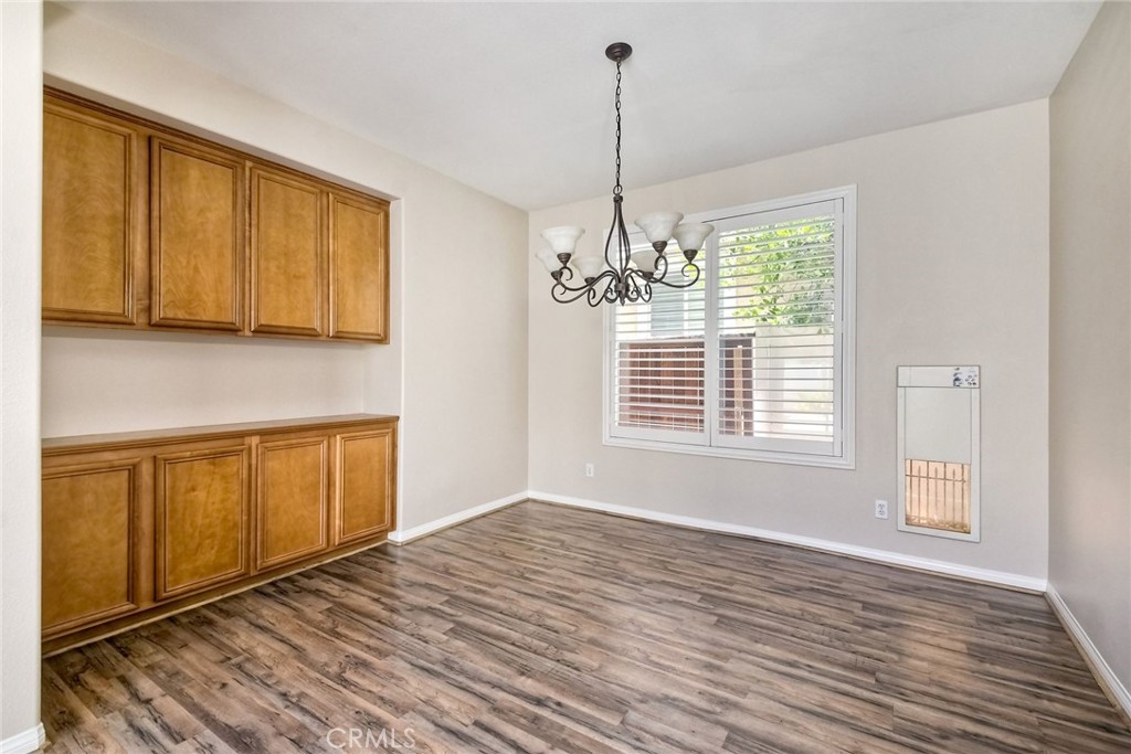 28961 Savannah Drive Temecula, CA 92591 - Photo 10 of 54 a view of an empty room with window and wooden floor