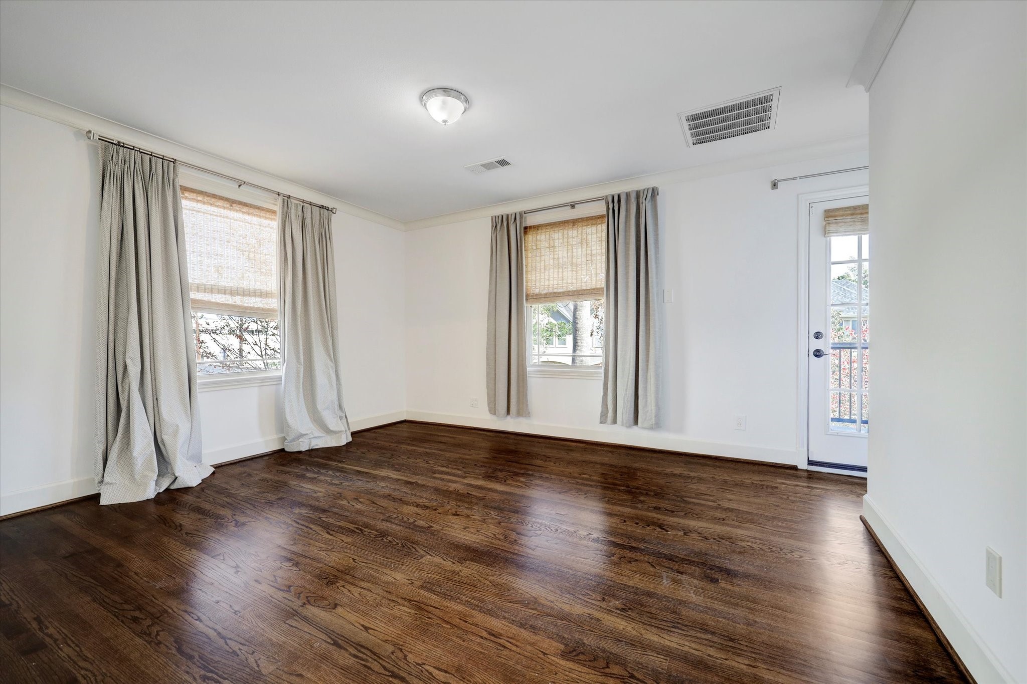 2622 Westgate Drive Houston, TX 77098 - Photo 11 of 20 an empty room with wooden floor and windows