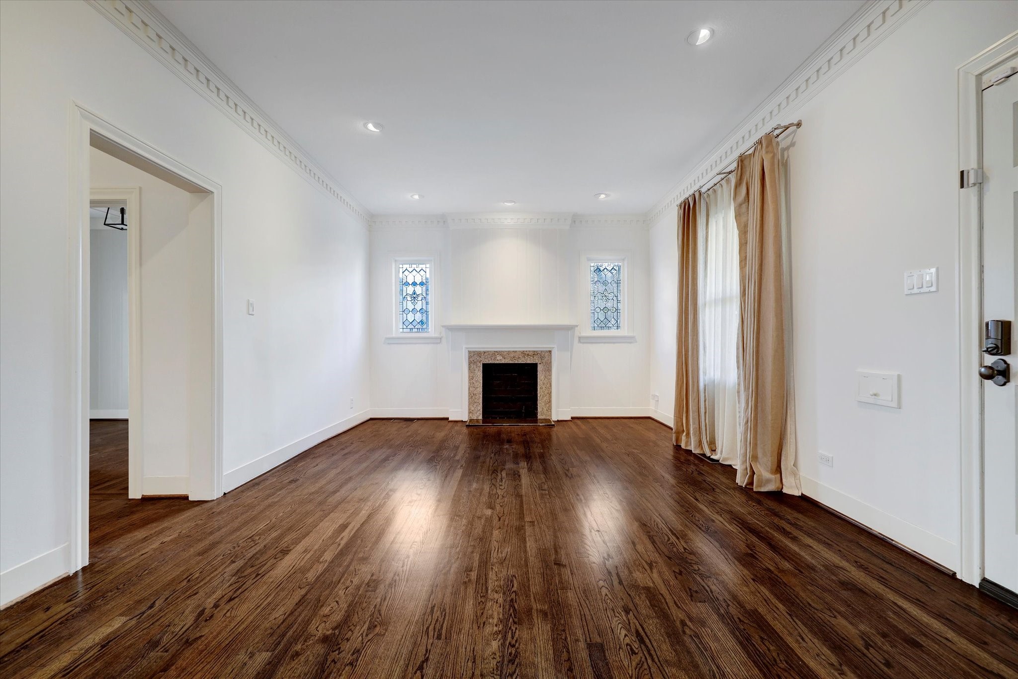 2622 Westgate Drive Houston, TX 77098 - Photo 3 of 20 an empty room with wooden floor fireplace and windows