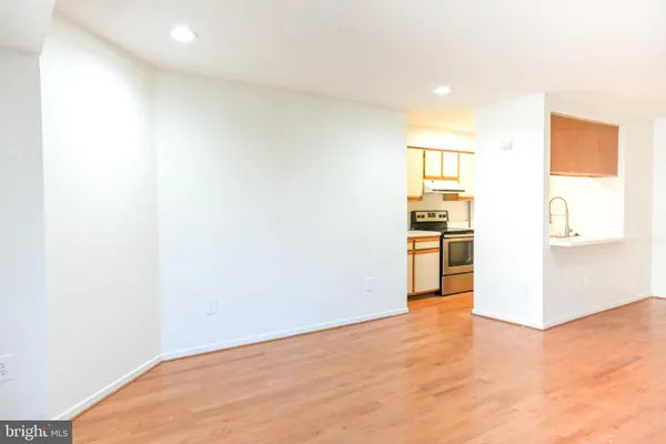 a view of a kitchen with wooden floor and a refrigerator