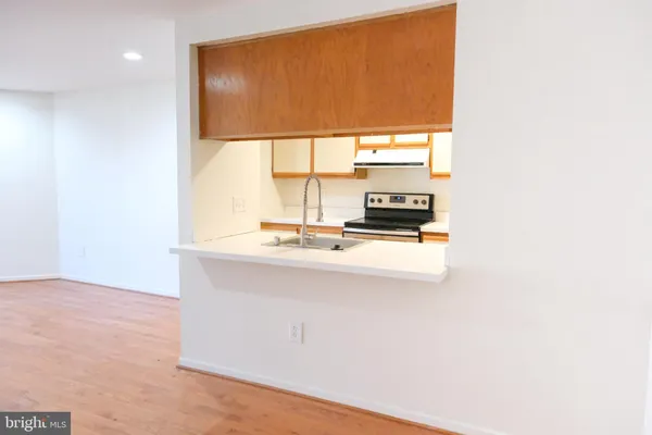 a kitchen that has a microwave a stove and a refrigerator