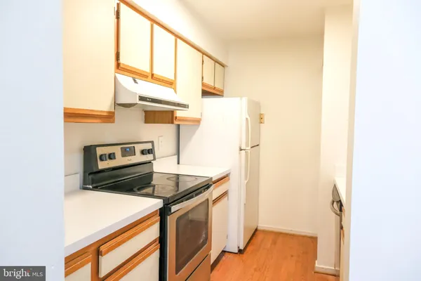 a kitchen with a refrigerator and a sink