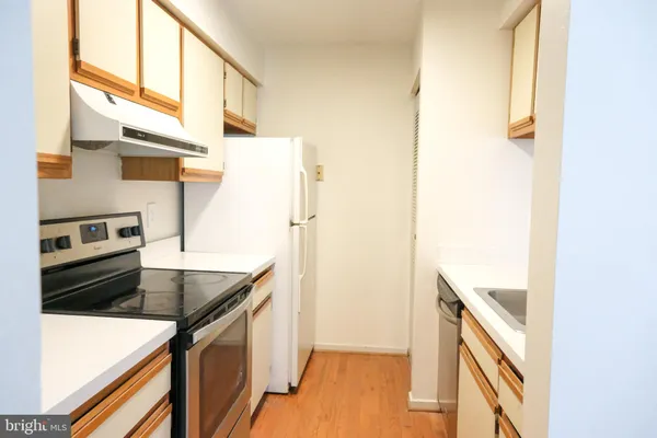 a view of a kitchen with a sink and a window