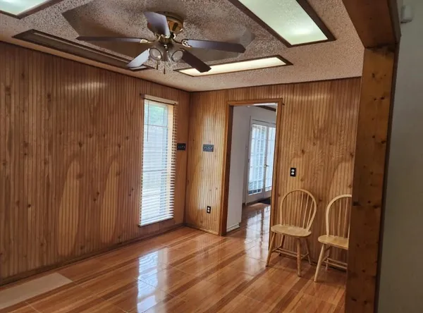 a view of a livingroom with furniture and hardwood floor