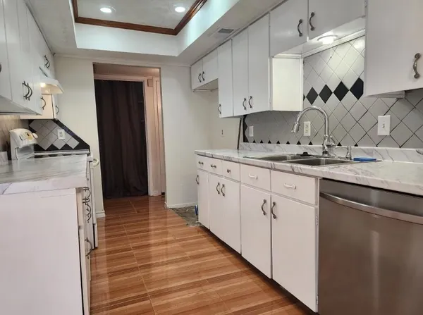 a kitchen with a sink stove and cabinets