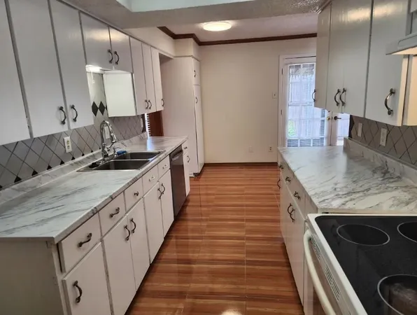 a bathroom with sink granite and a mirror