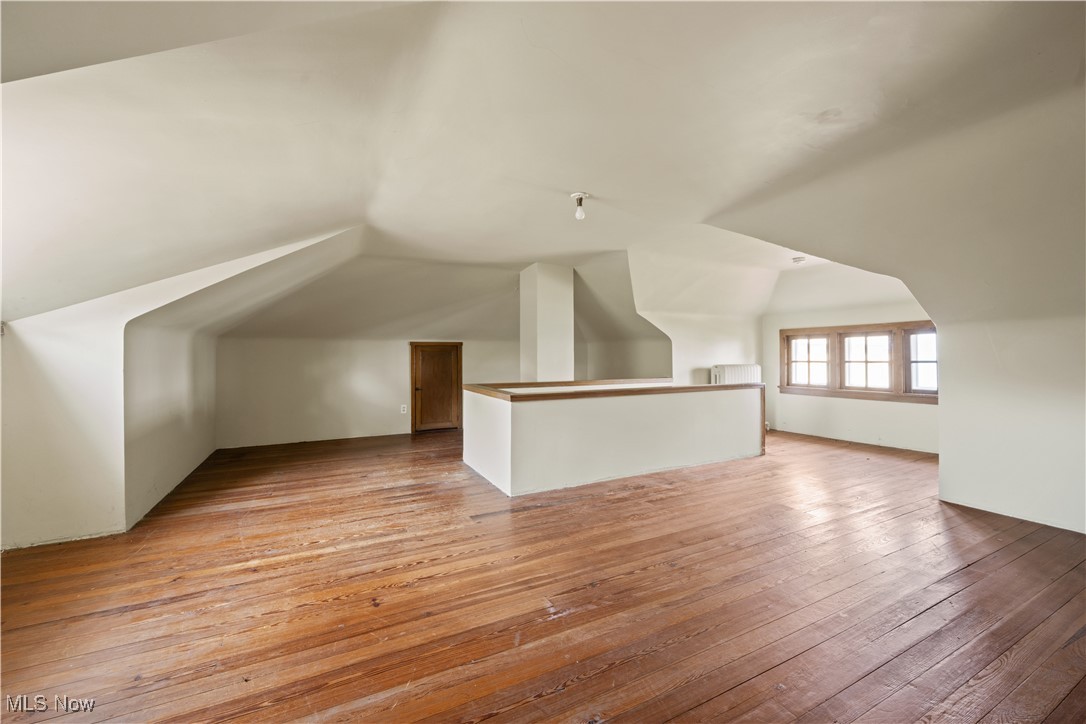 24510 Lake Road Bay Village, OH 44140 - Photo 44 of 45 Bonus room with lofted ceiling and light wood-style flooring
